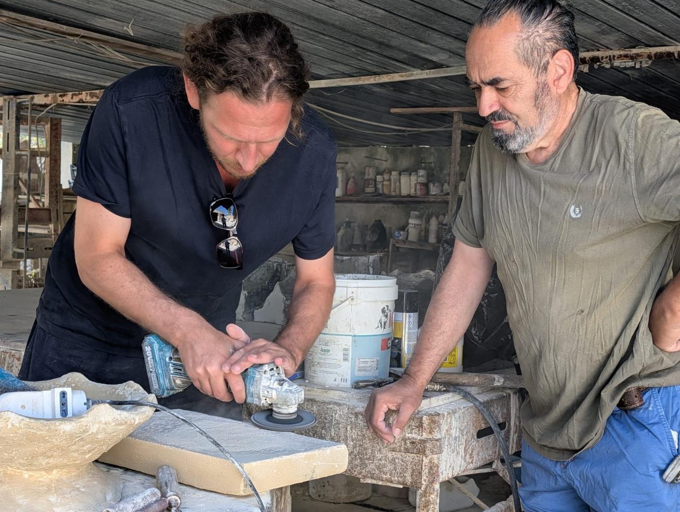 Andrea Mancuso and Giuseppe Calò working on a stone surface